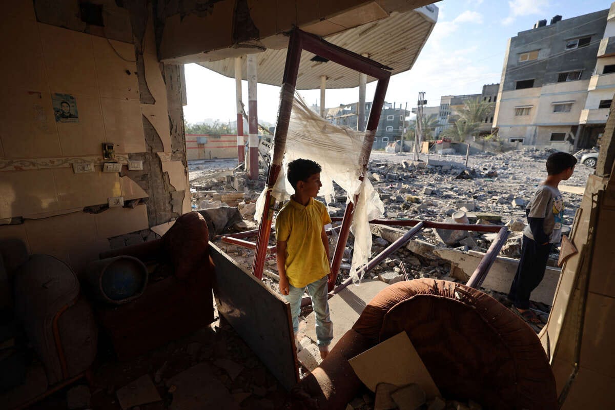 Children check a destroyed gas station after an Israeli strike in the Nuseirat refugee camp in the central Gaza Strip on May 20, 2025.