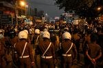 Police stand guard at as protestors take part in a demonstration against the surge in prices and shortage of fuel and other essential commodities in Colombo on April 3.
