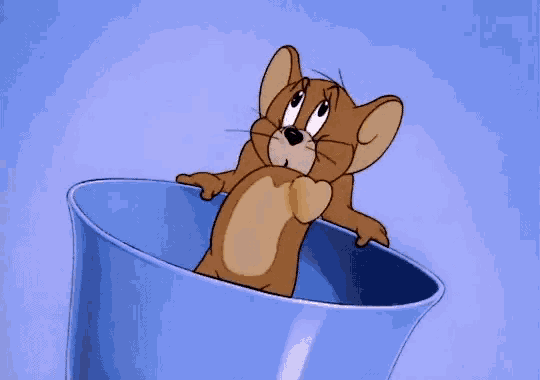 a cartoon mouse is sitting in a blue bowl a cartoon mouse is sitting in a blue bowl