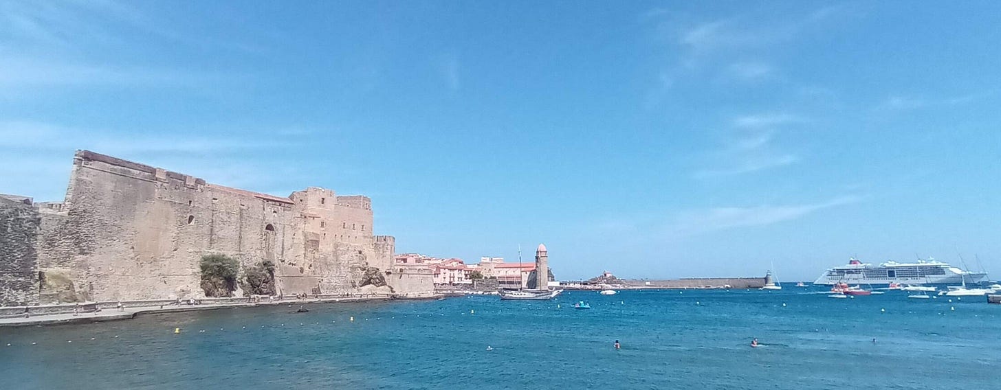 Fort / Castle at Collioure, on the right, the sea in the foreground, in the distance is a cruise ship