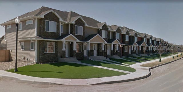 r/UrbanHell - a row of houses with a lawn