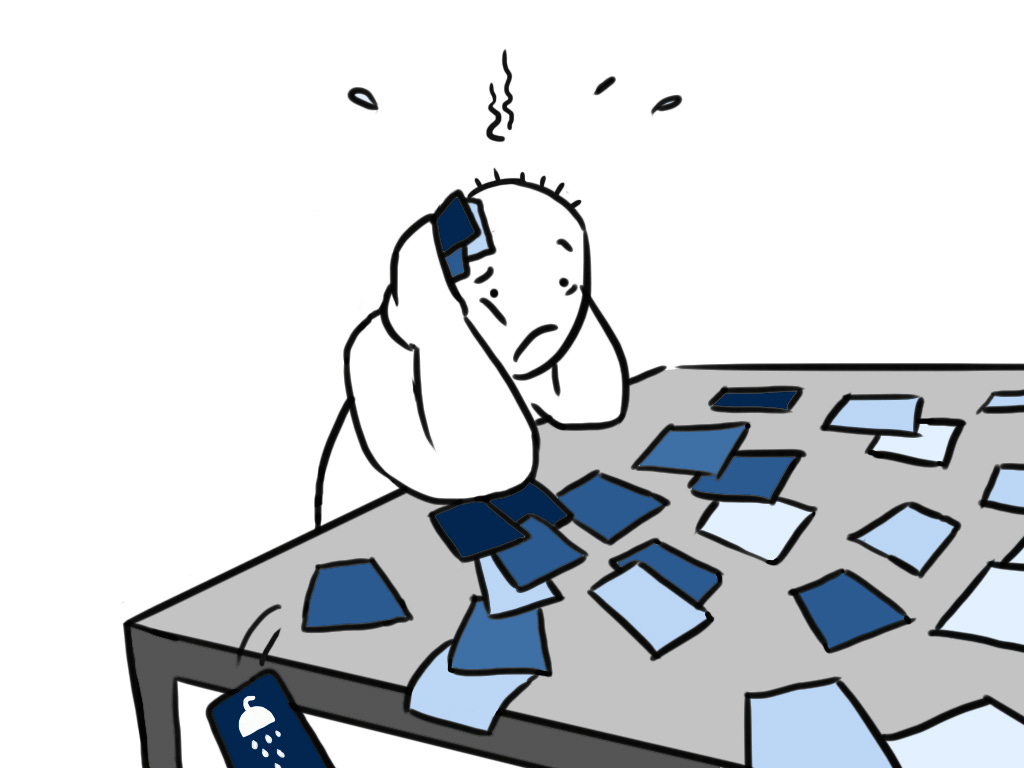 One person at a table, overwhelmed by all the cards. His “take a shower” card is falling off the table.