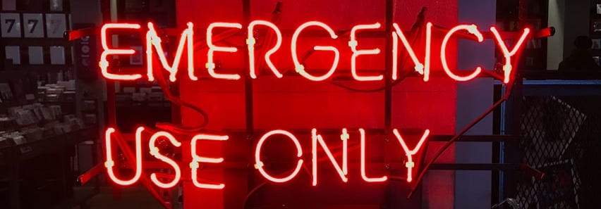 a neon sign that reads emergency use only