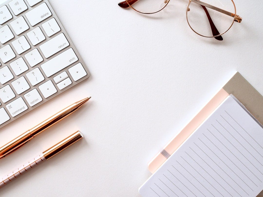 pen near black lined paper and eyeglasses pen near black lined paper and eyeglasses