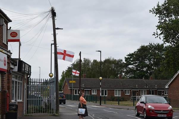 Flags hanging from lampposts on a quiet street