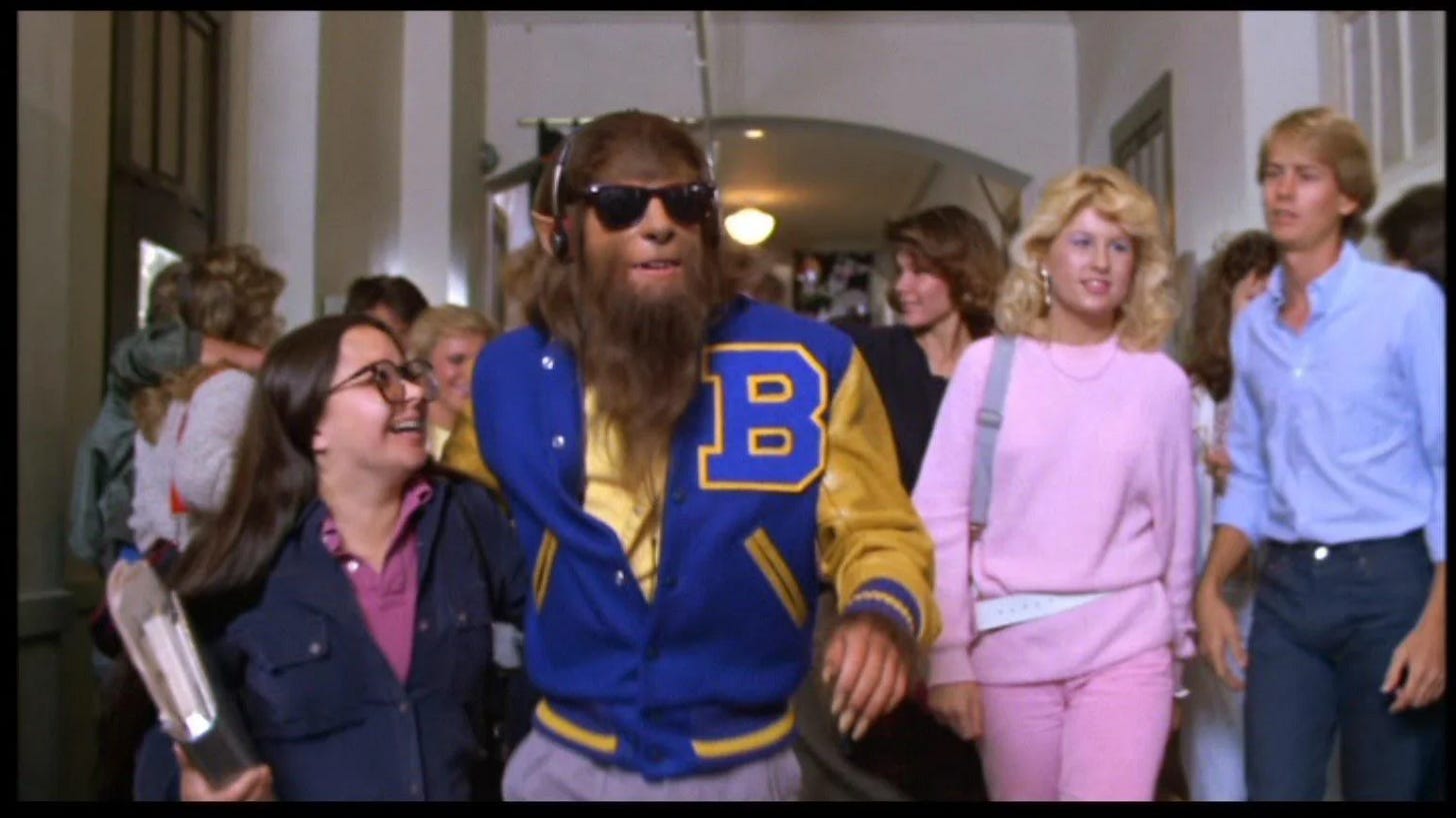 Teen Wolf (1985) - Scott Howard as the wolf walking down the hallway with other high school peers