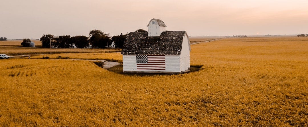 white and black house on brown field under white sky during daytime white and black house on brown field under white sky during daytime