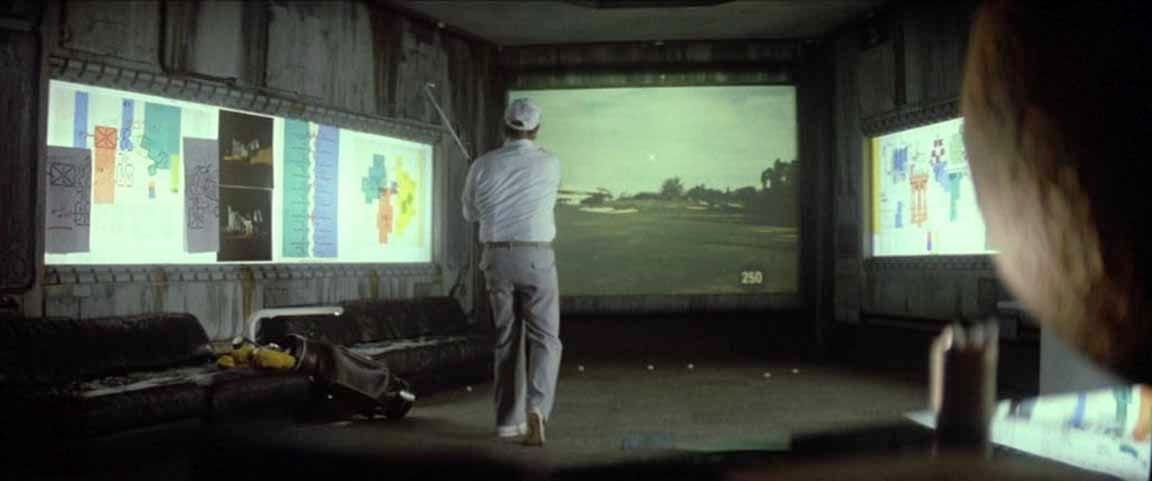 Peter Boyle's character playing Future golf, where you whack a ball onto a screen and it advances the image of the golf course Peter Boyle's character playing Future golf, where you whack a ball onto a screen and it advances the image of the golf course