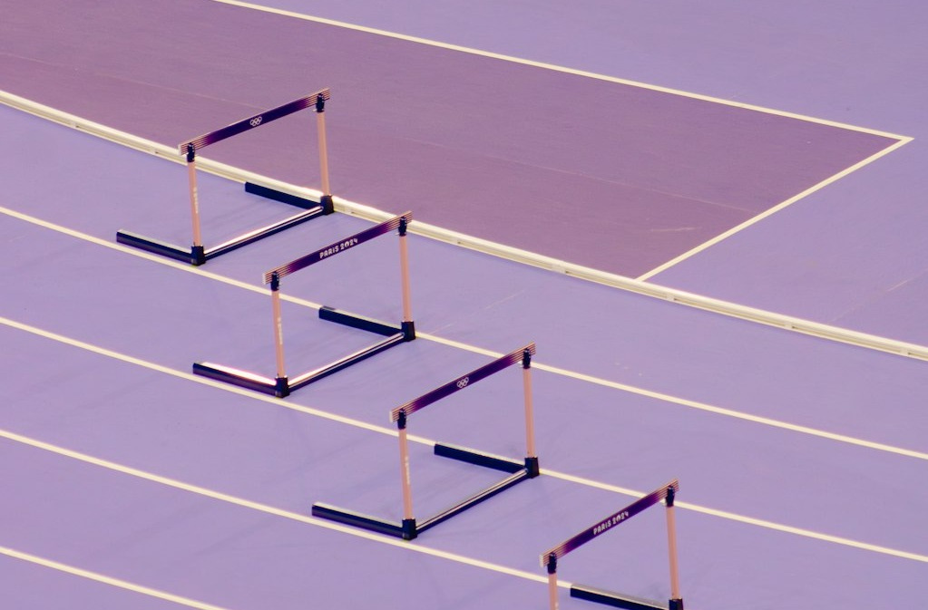 A purple track with a row of poles in the middle of it A purple track with a row of poles in the middle of it