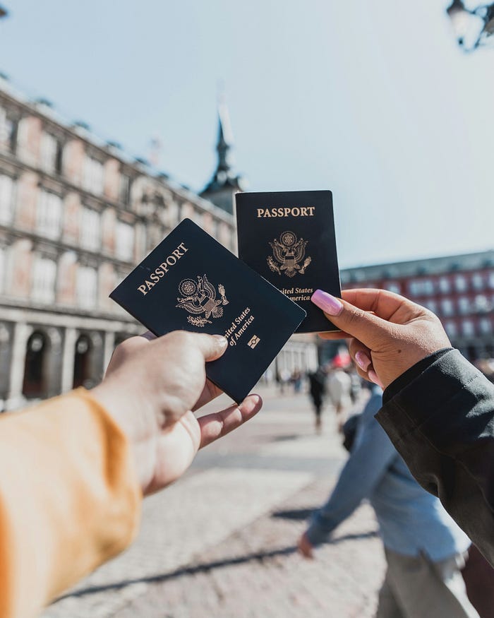 A couple of tourists hold up United States passports. A couple of tourists hold up United States passports.