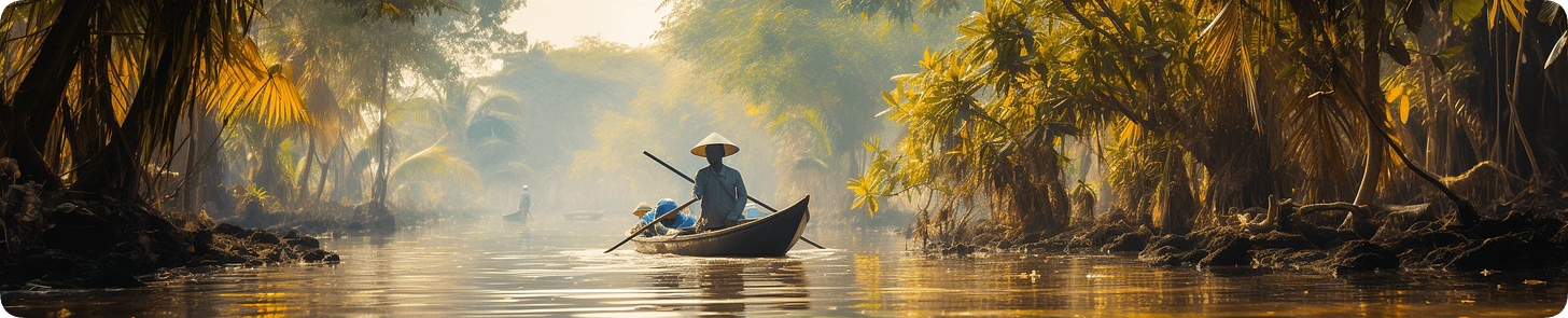 Person paddling a boat through a sunlit, Vietnamese waterway lined with verdant foliage.