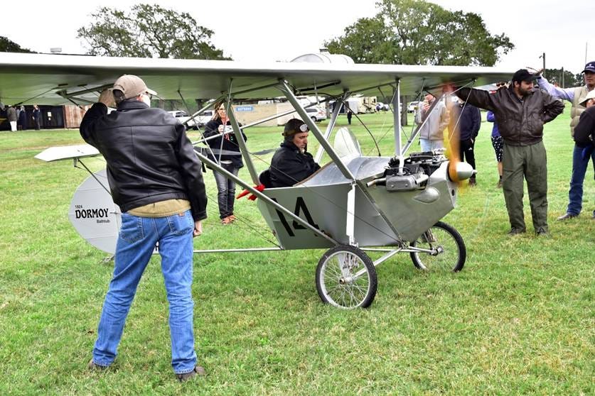 A person standing next to a small plane

AI-generated content may be incorrect.