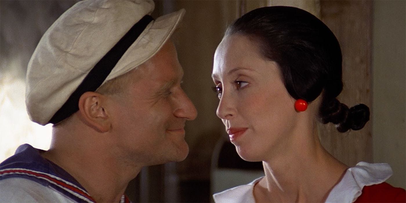 Robin Williams and Shelley in Popeye, looking lovingly at each other