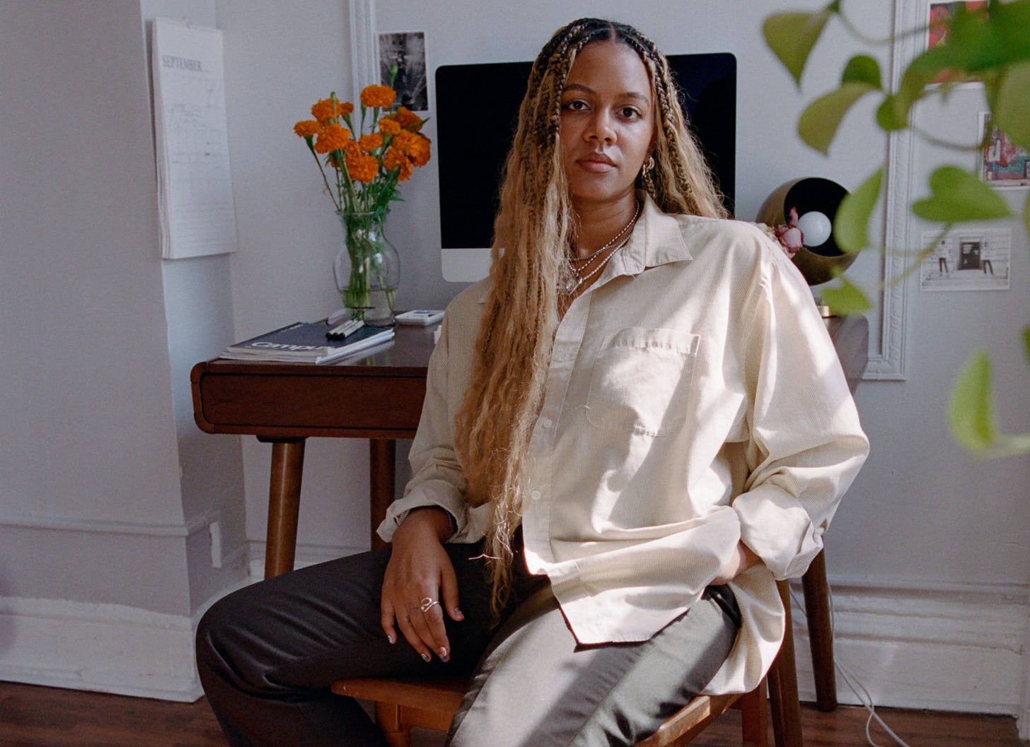 Photo of Peyton Dix sitting in front of a desk wearing a white button down and black pants