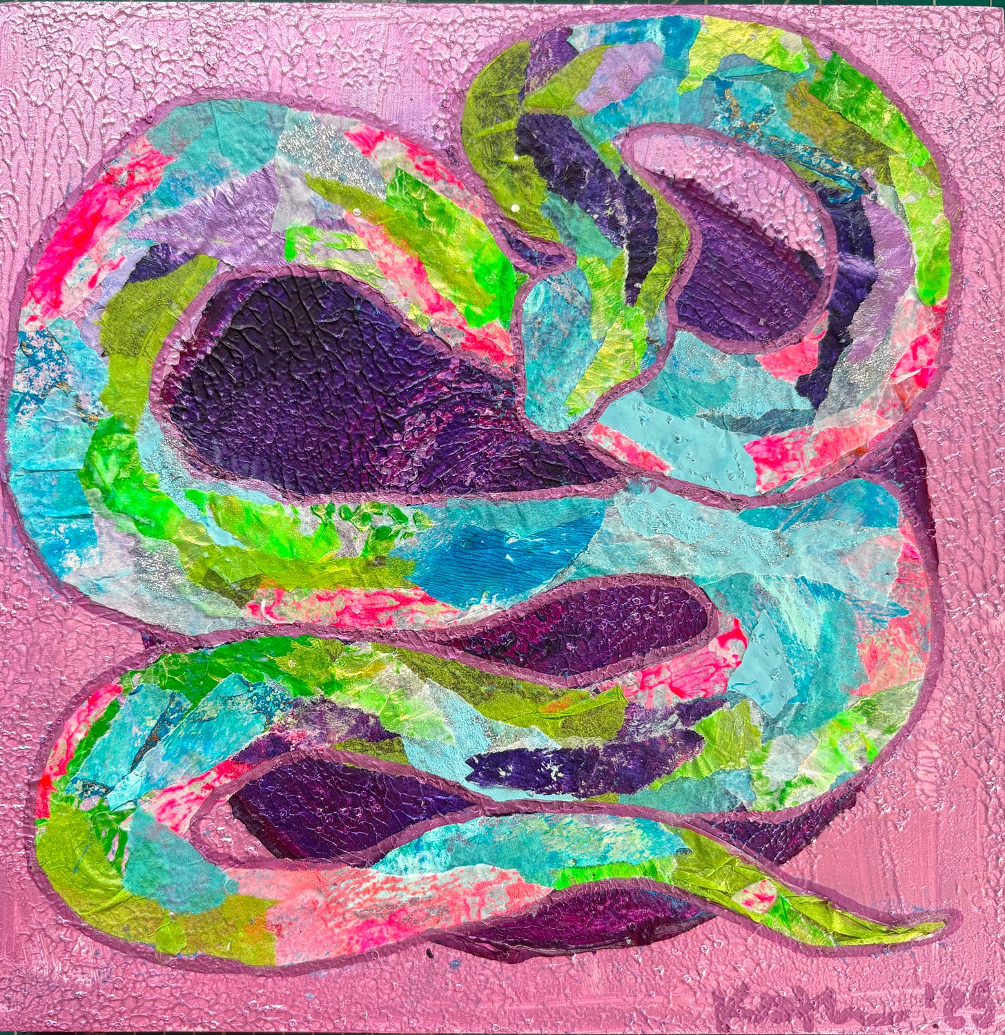 A coiled snake made out of multi-colored paper on a lilac background with a purple circle.