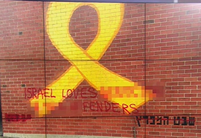 A yellow ribbon painted on a brick wall

AI-generated content may be incorrect.
