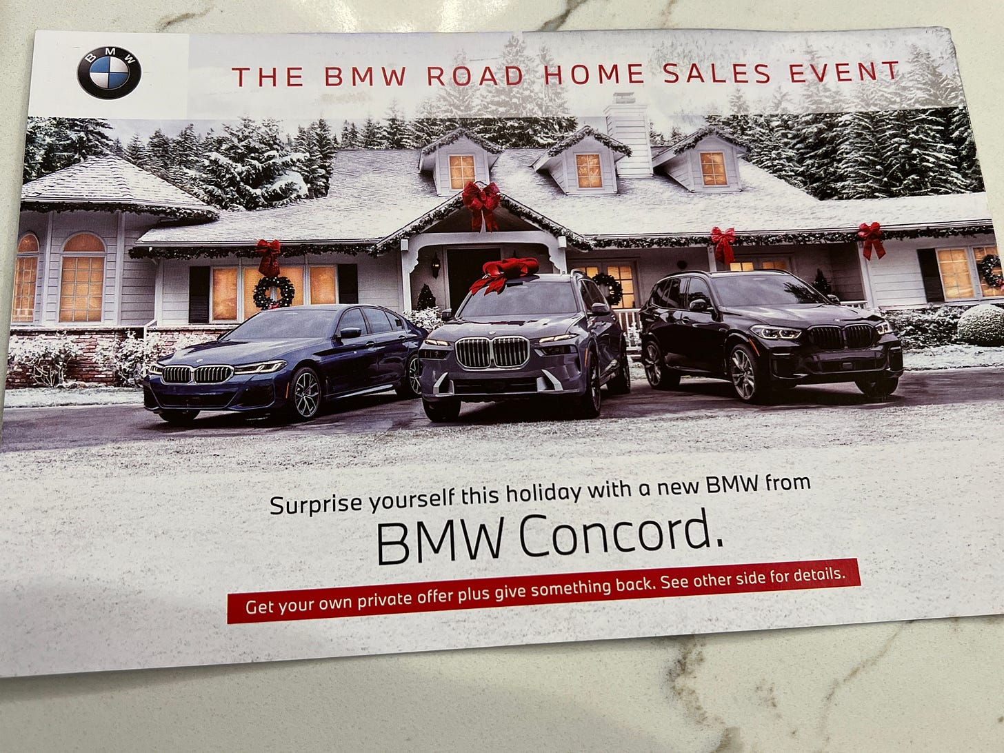 A mailer for a local BMW dealer showing three BMWs, none of this are electric.