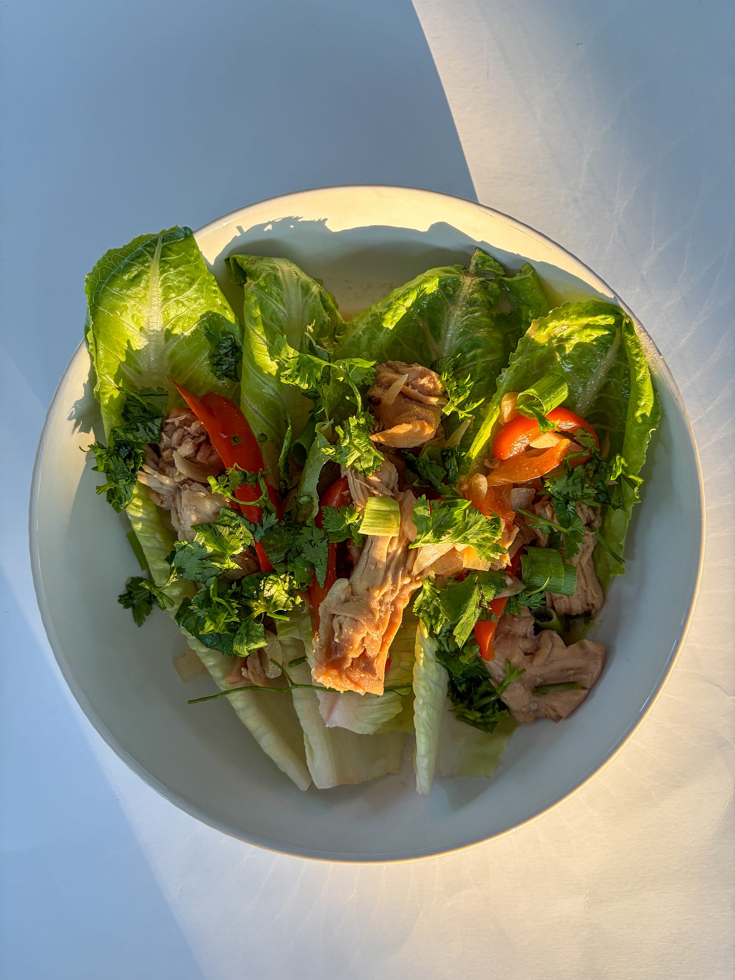 Miso chicken lettuce wraps in a white bowl