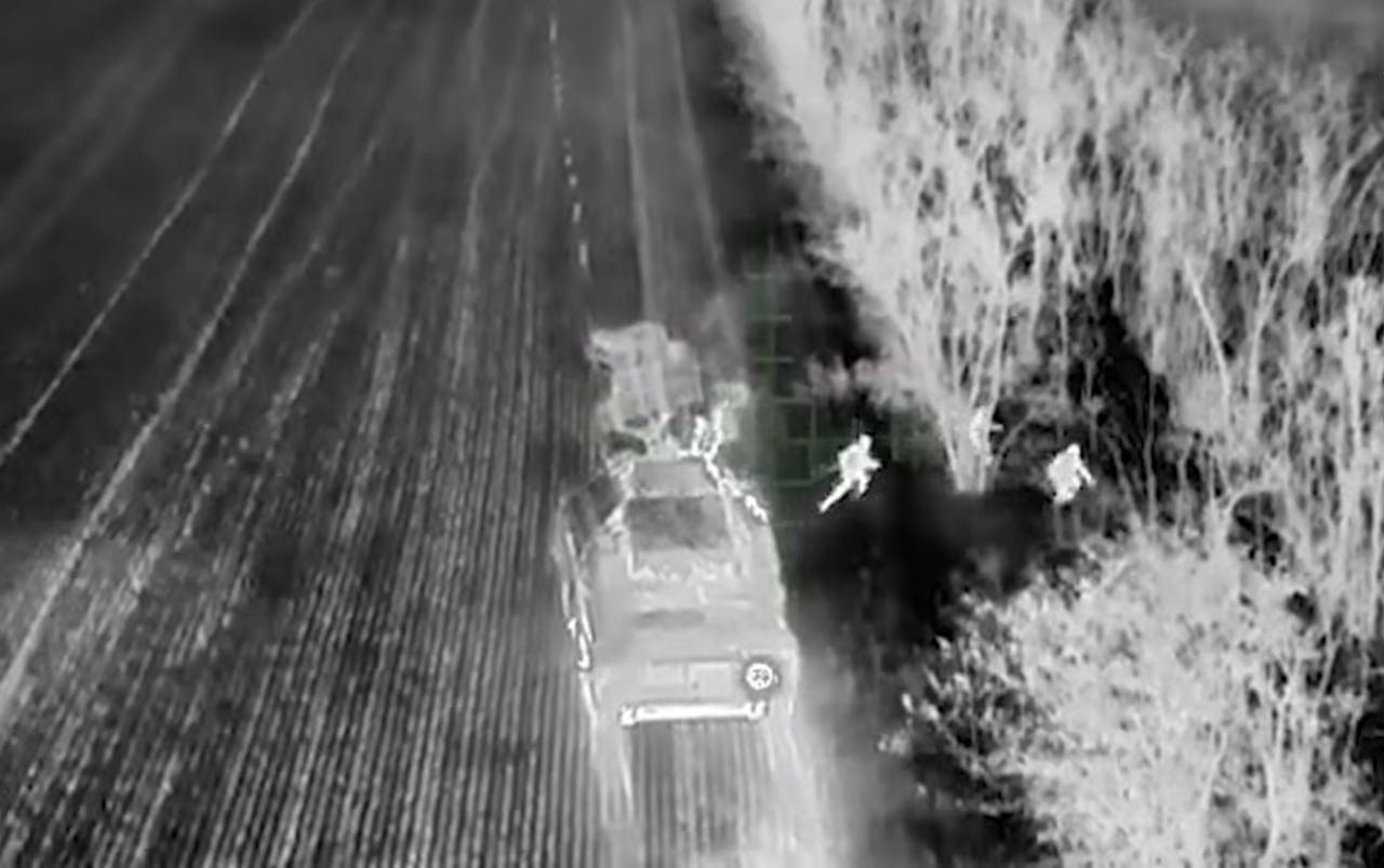 An image from an infrared camera shows Russian soldiers fleeing a burning vehicle as a drone piloted by Lasar's Group closes in.