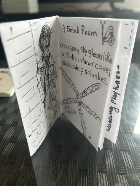 A black and white magazine with the photo of a girl reading a book on one side and a starfish and haiku on the other.