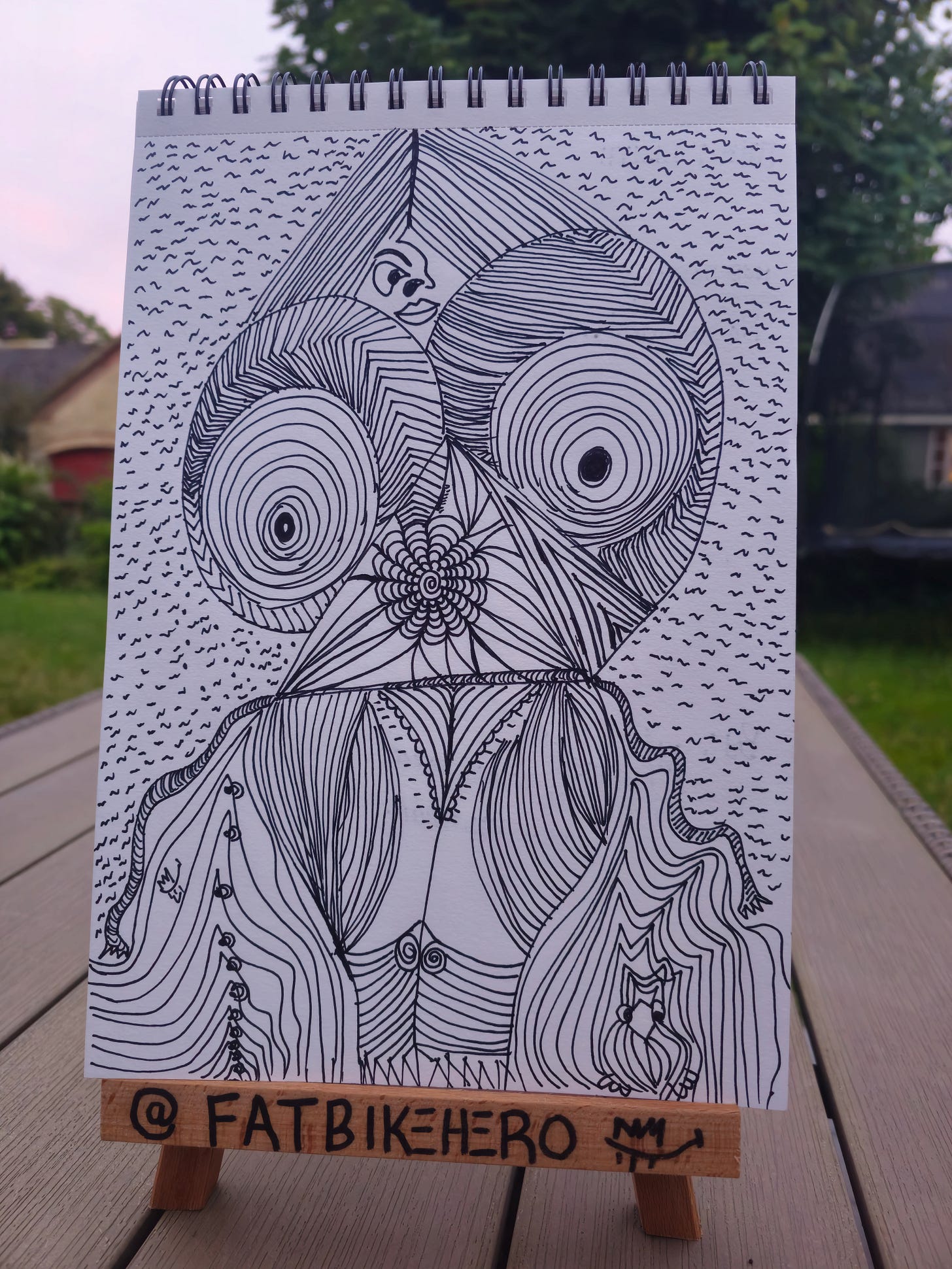 “Hand-drawn ink artwork titled Lilith by FatbikeHero, depicting a mythic female figure composed of dense circular and flowing line patterns, created as a human-made critique of AI aesthetics.”