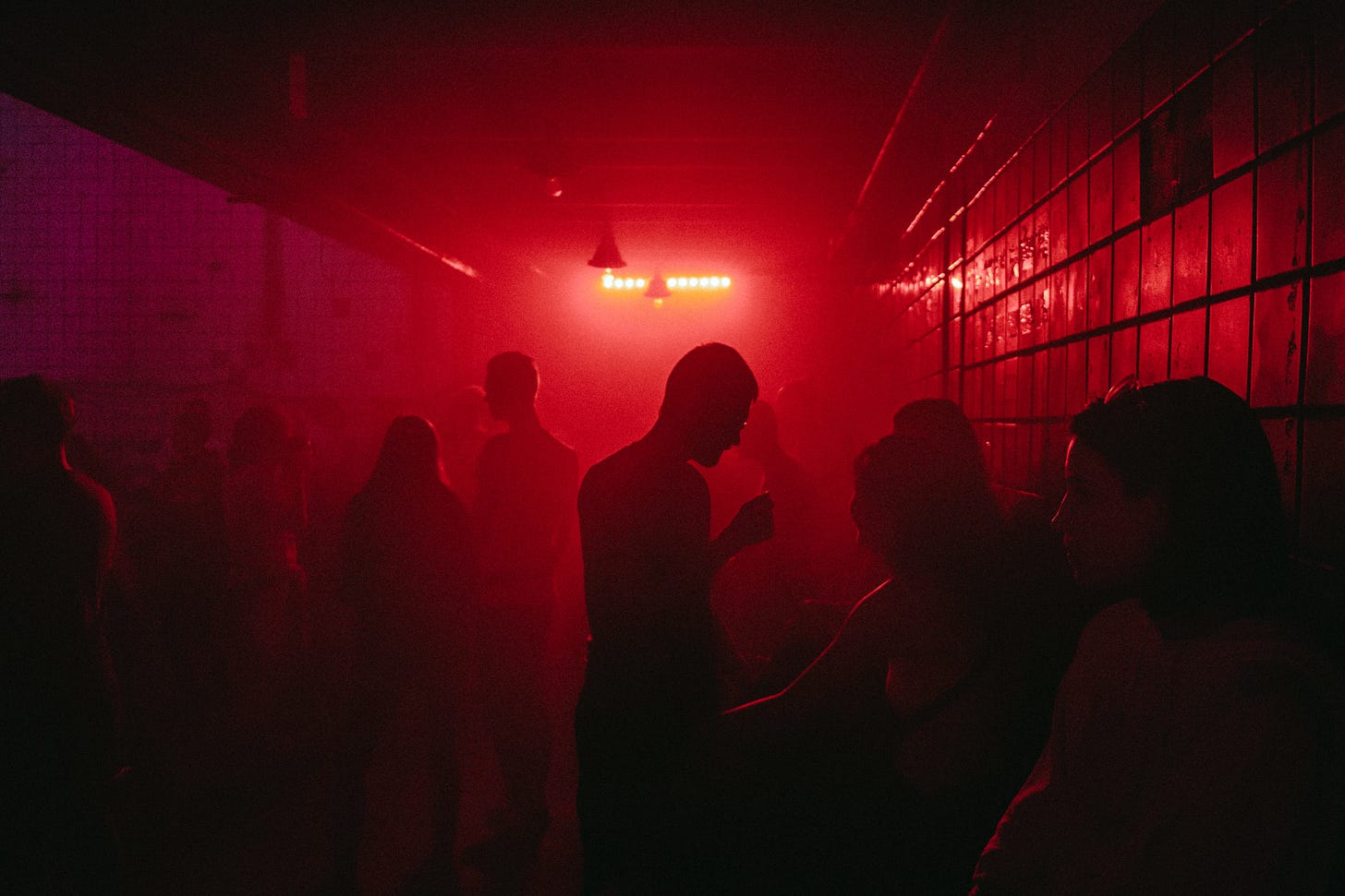 Picture of a cool, dimly-lit smoky club scene with people talking silhouetted in red. Picture of a cool, dimly-lit smoky club scene with people talking silhouetted in red.