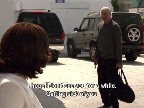This may contain: an older man is walking down the street with a woman holding a handbag and talking to him