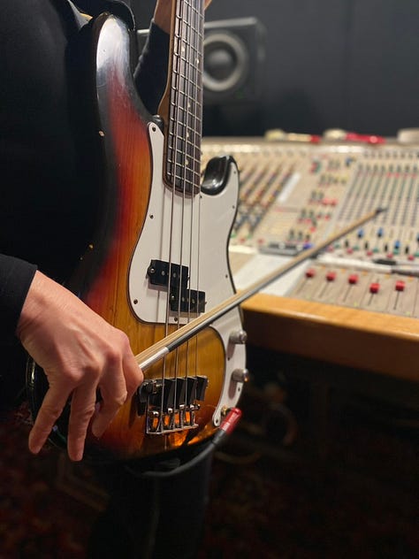 Musical equipment and people inside a recording studio