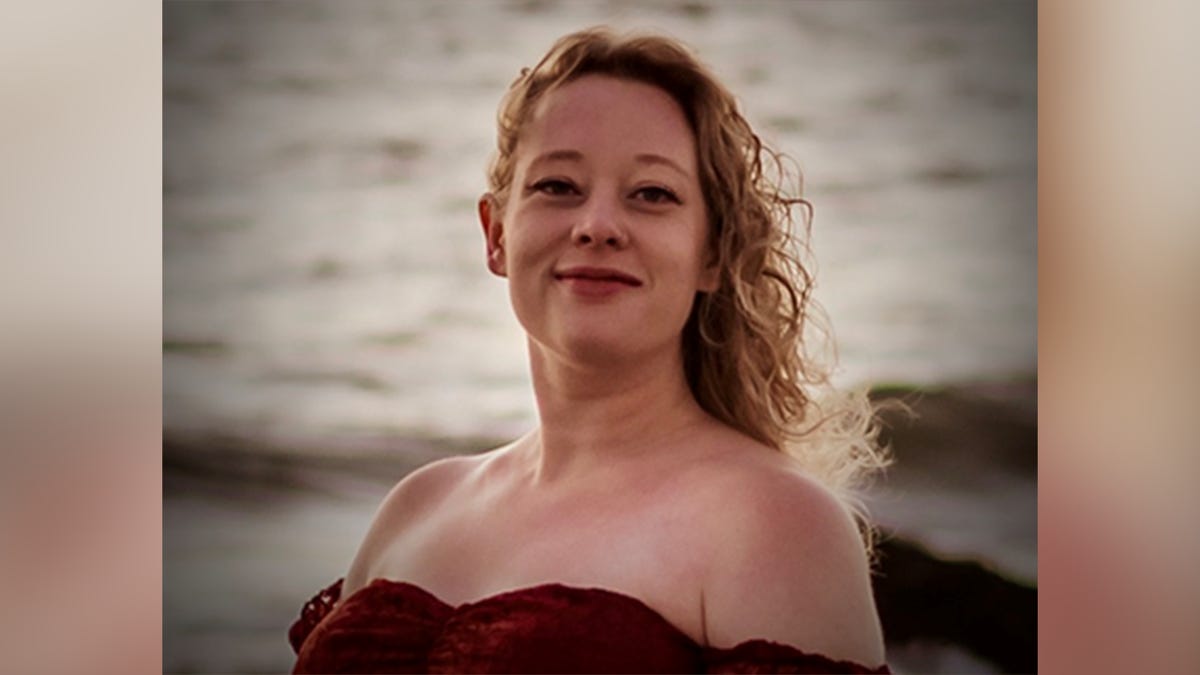 Renee Nicole Good in a beachside portrait, smiling with ocean water in the background. Renee Nicole Good in a beachside portrait, smiling with ocean water in the background.