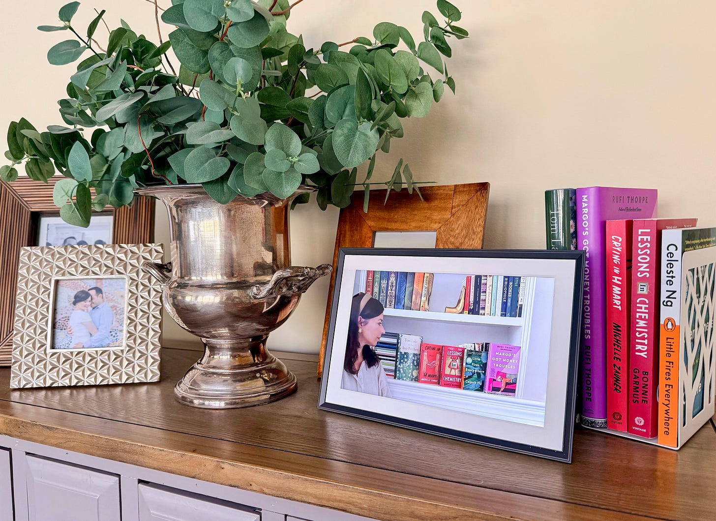 aura frame on table with books about moms