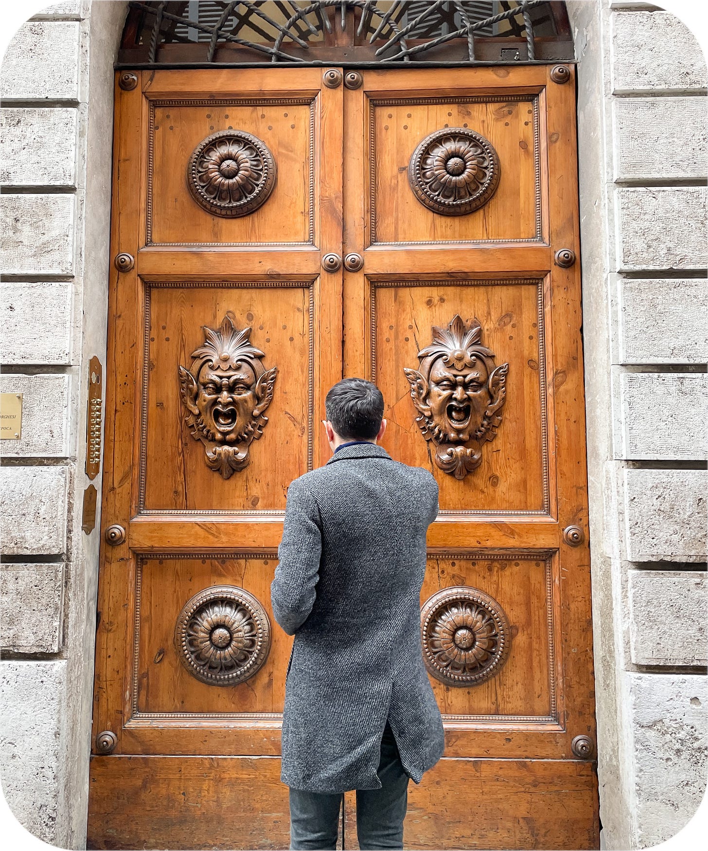 Fabulous door with grotesques. Siena, Italy.