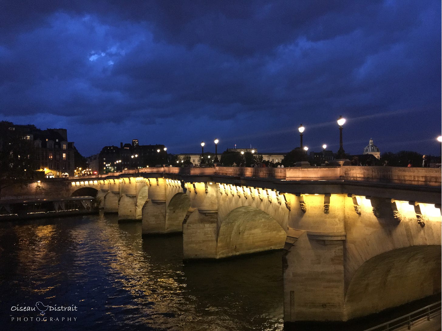 A beautiful twilight blue sky on a golden lighting bridge of Pont Neuf in Paris on river the Seine, Paris. A beautiful twilight blue sky on a golden lighting bridge of Pont Neuf in Paris on river the Seine, Paris.