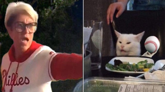 A woman wearing a white and red baseball jersey with "Phillies" text, yelling and pointing forward. A white cat with a confused expression sitting at a dinner table, with a baseball and a plate of food nearby. A watermark reads "@TheRicanMemes". A woman wearing a white and red baseball jersey with "Phillies" text, yelling and pointing forward. A white cat with a confused expression sitting at a dinner table, with a baseball and a plate of food nearby. A watermark reads "@TheRicanMemes".