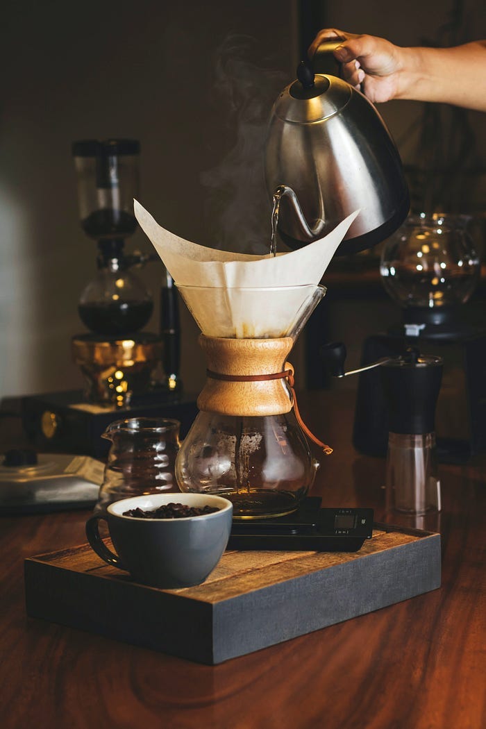 A barista makes a pour-over pot of coffee. A barista makes a pour-over pot of coffee.