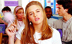 Movie gif. Alicia Silverstone as Cher in Clueless stares pensively into space, lost in thought, fluffy pen in hand. Movie gif. Alicia Silverstone as Cher in Clueless stares pensively into space, lost in thought, fluffy pen in hand.