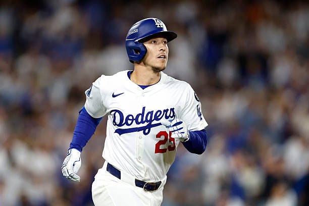 Tommy Edman of the Los Angeles Dodgers reacts after hitting a solo home run against the Cincinnati Reds during the third inning in game one of the...