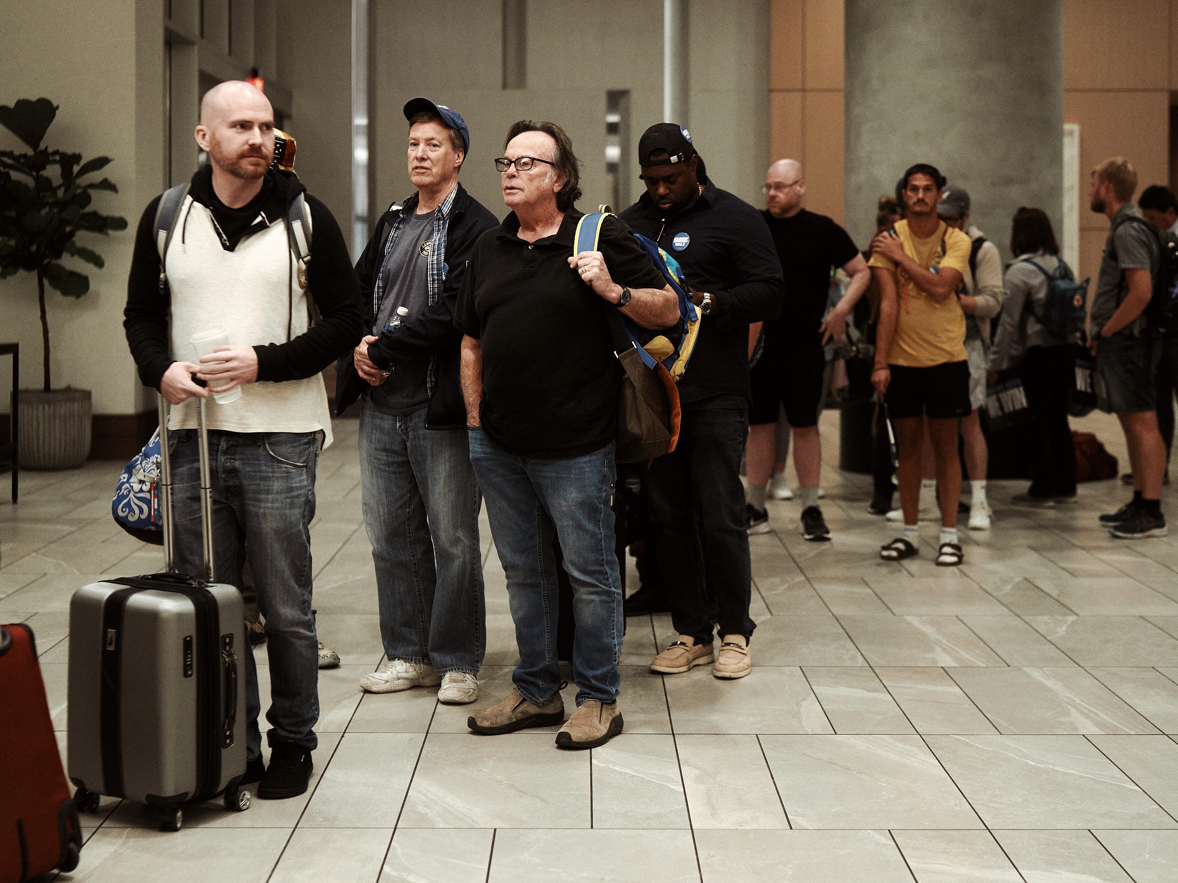 Campaign volunteers line up at the hotel check-in after the Phoenix, AZ arrival, photographed by Los Angeles photographer Afonso Salcedo