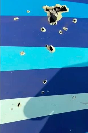 Suspected 'bullet holes' are seen on the stricken plane's clue-striped wreckage