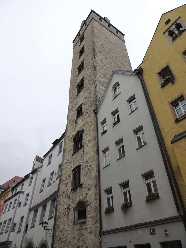 photos of buildings, a cathedral. a plaque, and a gravestone embedded in a wall