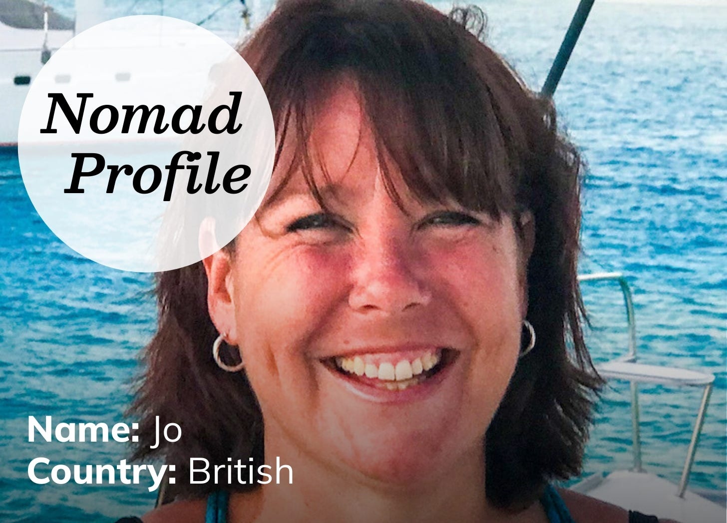 A 50-year-old white woman with brown hair and freckles is looking at the camera and smiling. She is on a sailboat, surrounded by blue water. A 50-year-old white woman with brown hair and freckles is looking at the camera and smiling. She is on a sailboat, surrounded by blue water.