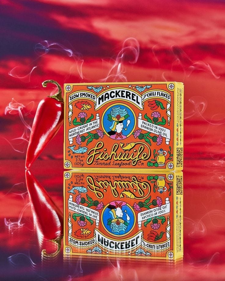 This may contain: a book with an orange cover and red ribbon around it, on a colorful background