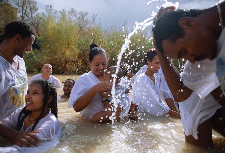 A group of people in a river

Description automatically generated