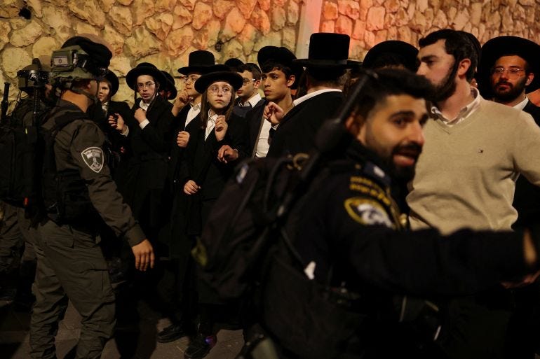 Israeli security forces secure the area during a protest by Ultra-Orthodox Jewish men against pressure to conscript men from their community into Israel's military, after, according to Israel's ambulance service, a person was killed in a collision involving a bus and several pedestrians, in Jerusalem, January 6, 2026. REUTERS/Ammar Awad