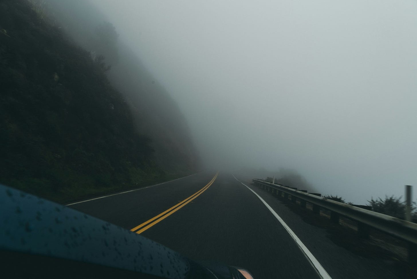 Foggy road from driver perspective Foggy road from driver perspective