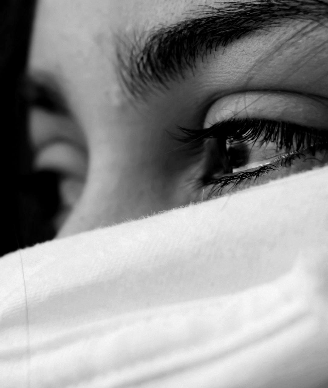 shallow focus of a woman's sad eyes