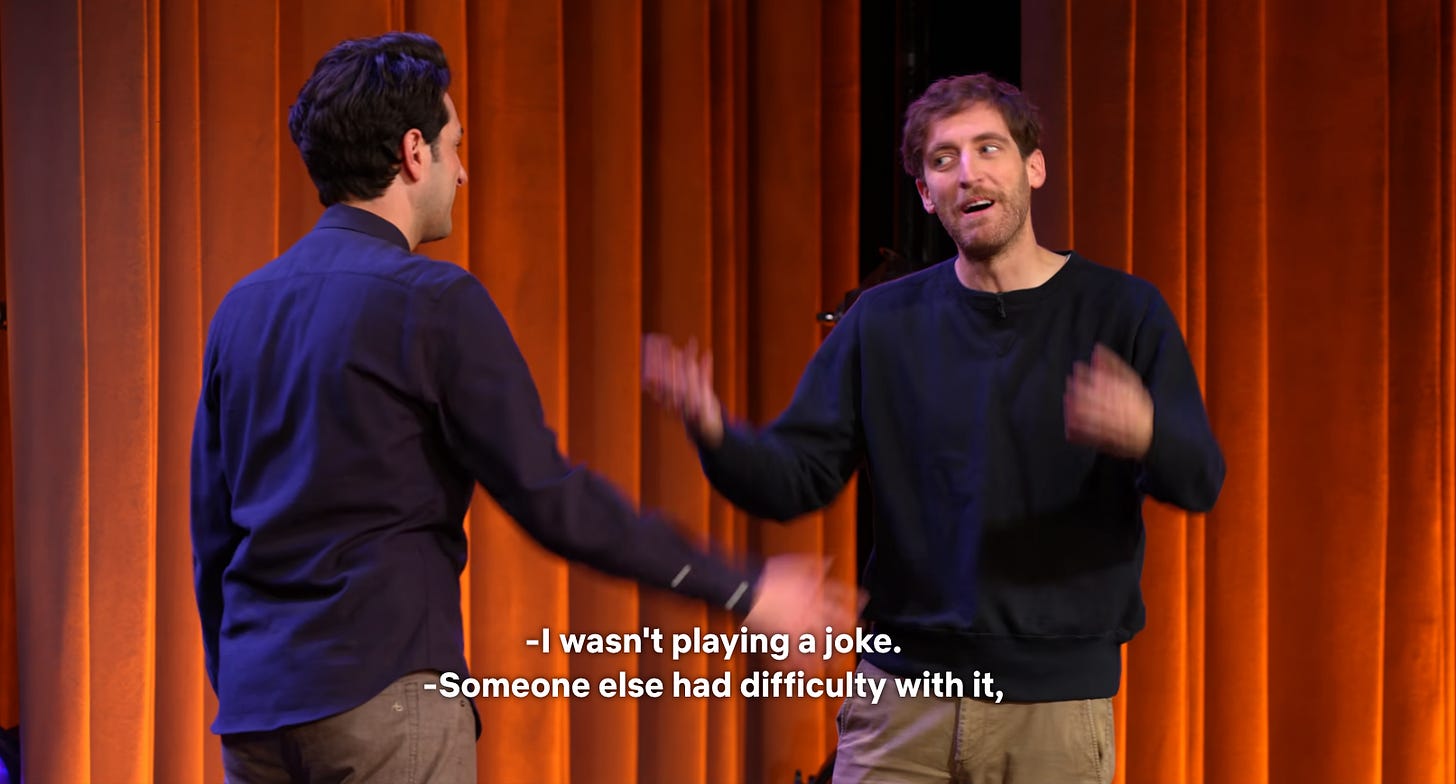 a screenshot of ben schwartz and thomas middleditch in conversation on stage, with ben schwartz (on the left) saying via closed caption "i wasn't playing a joke" and thomas middleditch saying "someone else had difficulty with it"