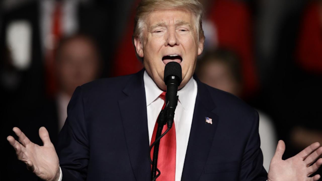 A person speaking into a microphone

Description automatically generated