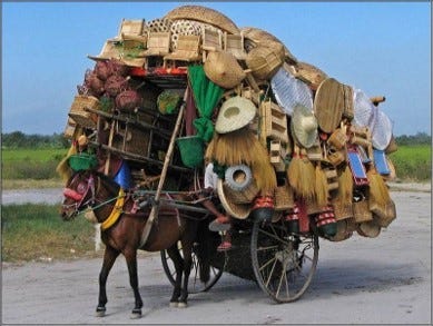 Overloaded donkey with baskets and hats on it’s back