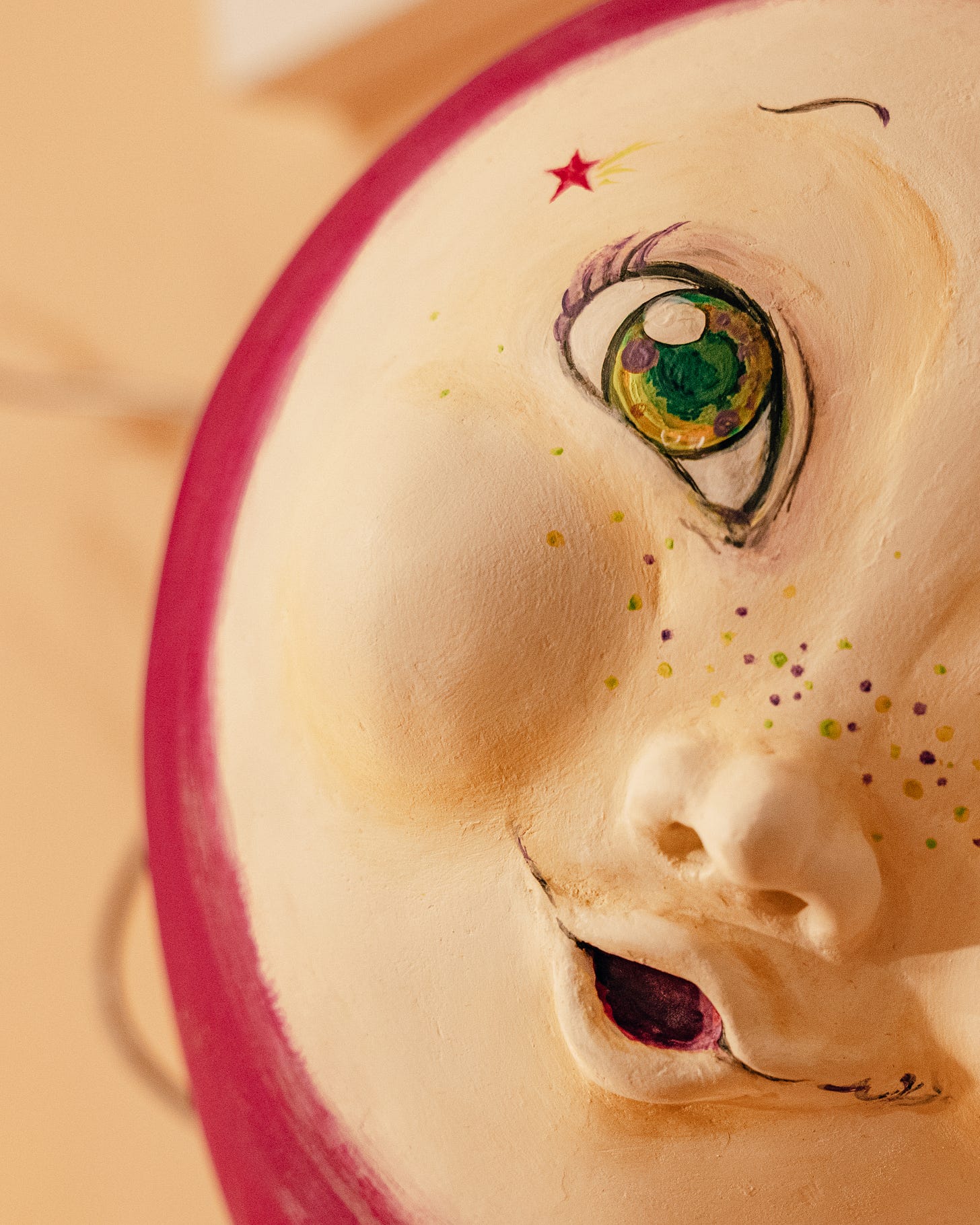 A painted face on a purple balloon