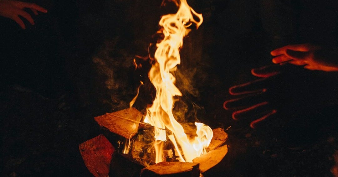 two people near bonfire